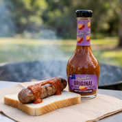Original hot sauce on a grilled sausage sandwich